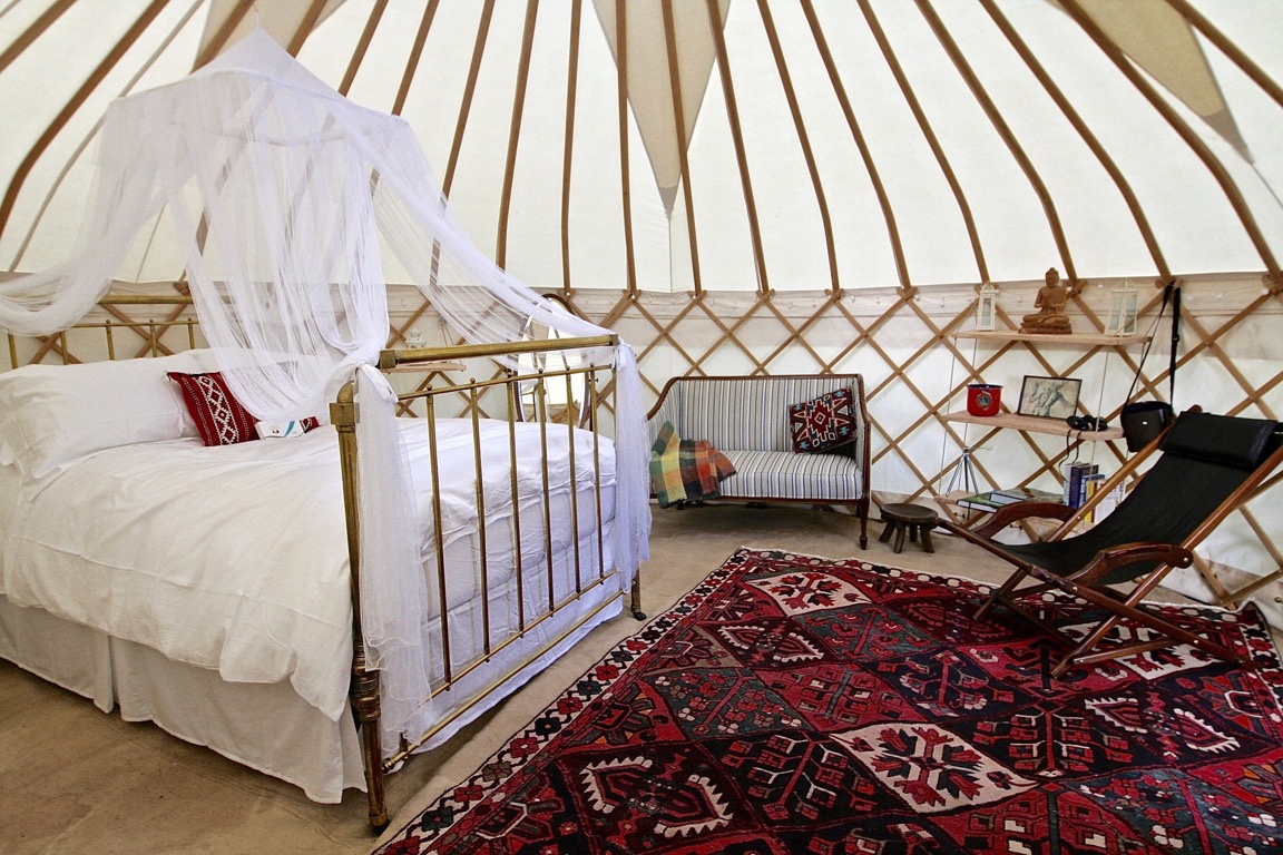 roundhouse-yurts-luxury-glamping-yurt-spanish-bed A Roundhouse Yurt with a stylish wedding night interior.