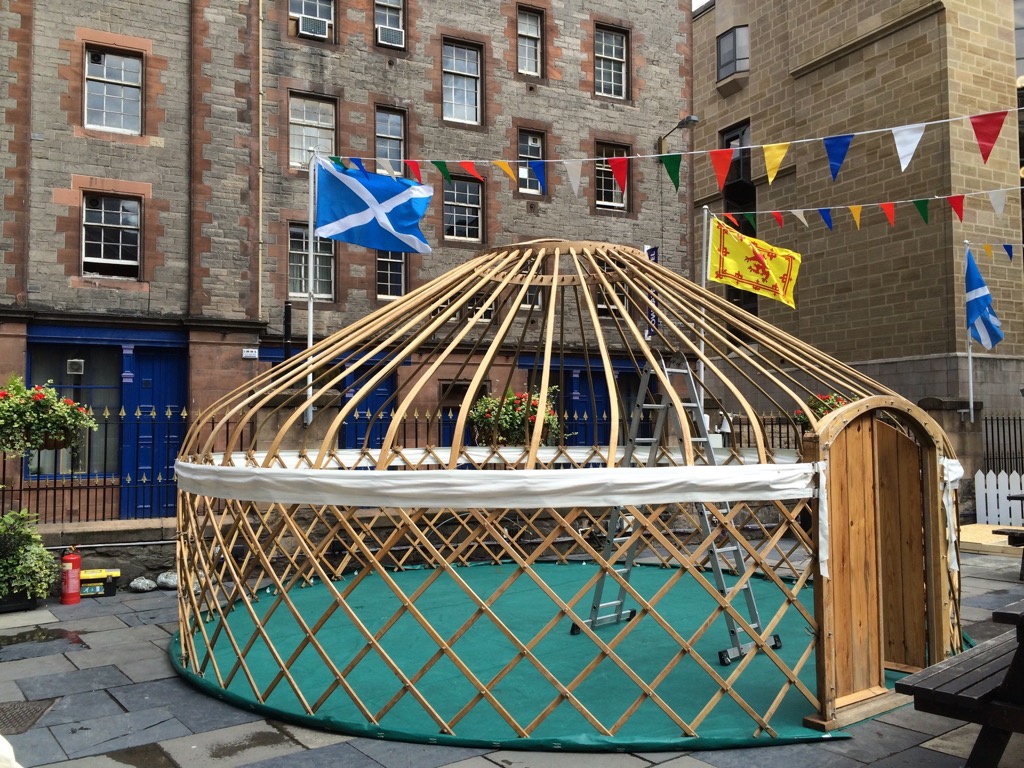 Erecting yurt on hard standing at festival Hire a Yurt for a luxury glamping weekend.