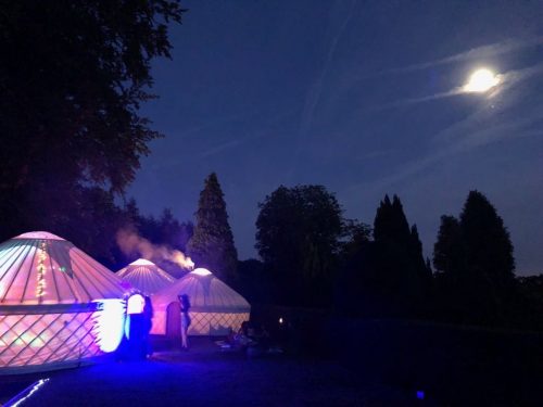 Guests enjoying a party in a collection of Roundhouse Yurts.