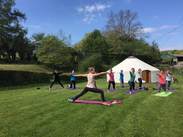 Yoga Yurts in use by a yoga class